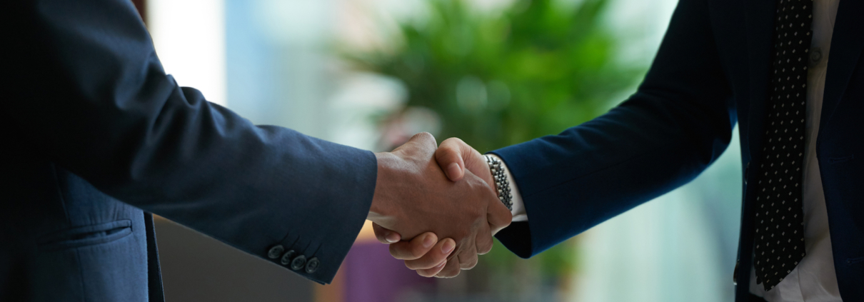 Close up of Clovis Law Group attorneys shaking hands